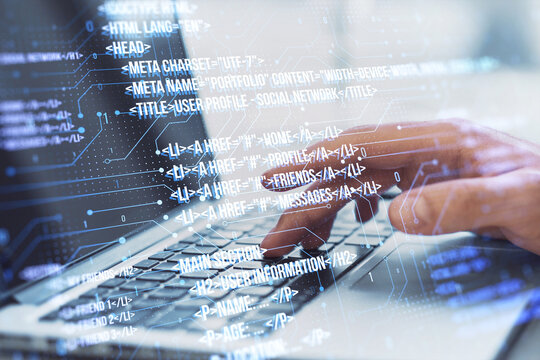 Close up of male hand using laptop keyboard with creative digital programming language on blurry background. Software developer and html concept. Double exposure.