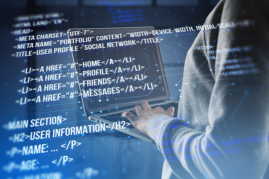 Close up of hacker using laptop with creative digital programming language on blurry background. Software developer, hacking, malware and html concept. Double exposure.
