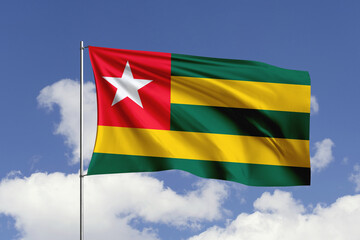 Togo flag fluttering in the wind on sky.