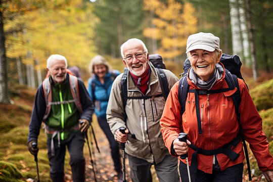 A diverse group of elderly friends, all in their 70s, hiking together on a mountain trail during early autumn
