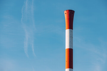 Heating plant chimney against autumn cold sky