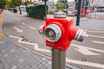Red fire hydrant at city street, emergency and safety concept