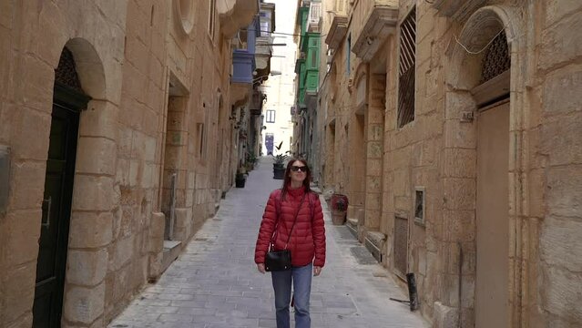 A girl walks in the old town of Malta.