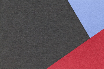 Texture of craft black color paper background with blue and red border. Vintage abstract cardboard.