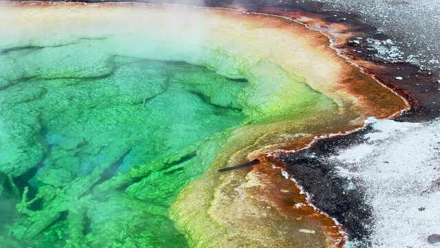 Morning Glory Opal Pool Grand Prismatic Spring West Yellowstone National Park Old Faithful Grand loop geysers scenic Wyoming Idaho mist steam thermal colorful yellow morning cinematic slowly pan left