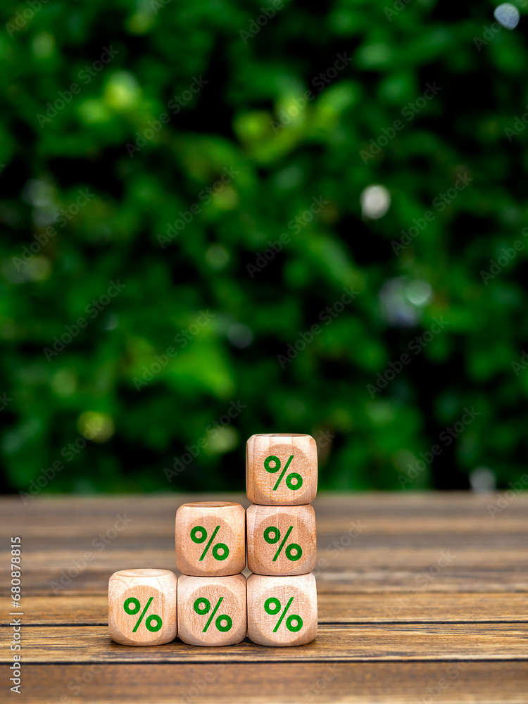 Poster green percentage icon on wooden cube blocks build as business chart steps on wood table on tree back