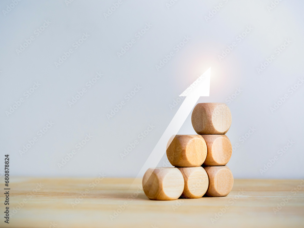 Poster rise up glowing arrow on wooden cube blocks as a business chart steps isolated on white background w