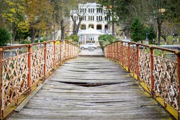 Old bridge over the river, in the city. Old dilapidated bridge