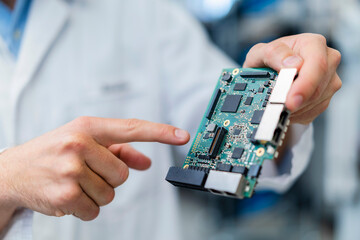 Hand of technician pinting at motherboard
