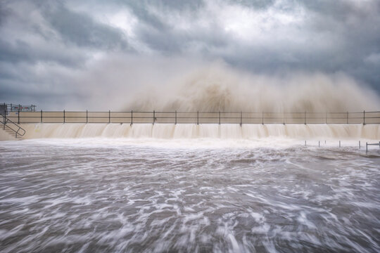 UK, Scotland, North Berwick, Long exposure of waves breaking over harbor wall during Storm Babet