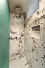 Luxurious Bathroom Interior Design: Elegant Walk-In Rain Shower with Marble-Like Tiled Surround. Perfect for use in interior design concepts, home decor publications, and architectural presentations