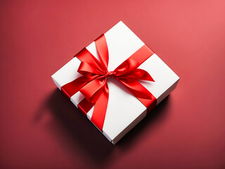 white present box tied with red ribbon bow isolated on dark red background