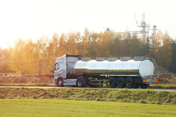 Liquid Fuel and Oil Cargo Semi Truck on the Highway. Compressed Gas Carrier Truck in the Evening...