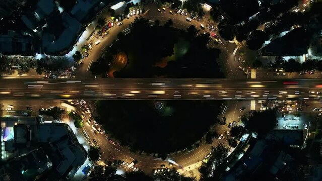 Beautiful top view time-lapse of car traffic at roundabout lane and buildings. Aerial view of Mumbai. Urban cityscape concept or abstract of advanced innovation, financial technology, and energy power