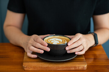 Fototapeta na wymiar hot latte art coffee on table, relax time