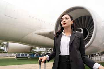 Tourist travel concept. young business woman holding the luggage at the airport