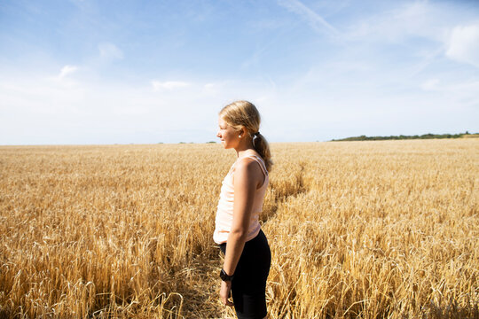 Girl standing in wheat field