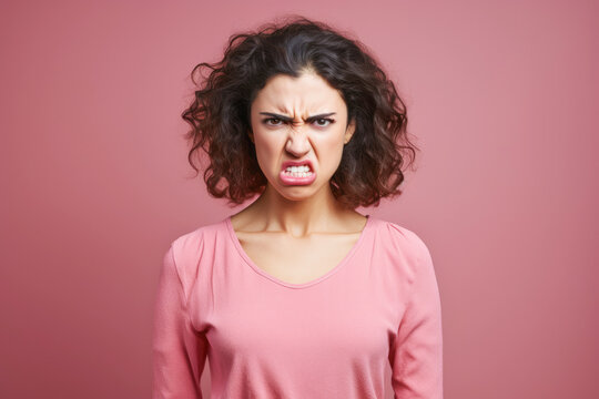 A young woman with an evil expression, making photography difficult in a tense and stressful situation.
