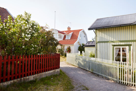 Houses with picket fences under clear sky