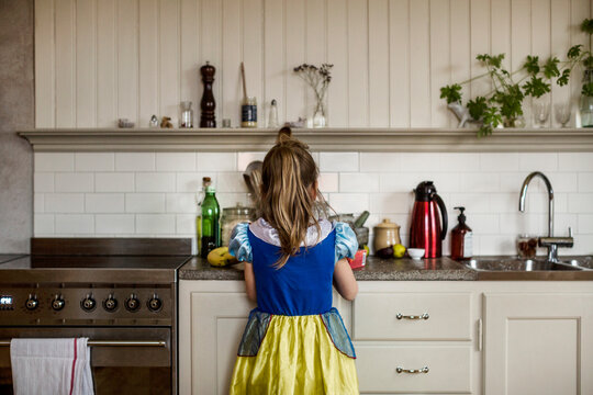 Girl with costume in kitchen