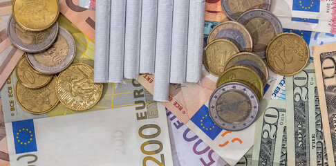 tobacoo on dollar and euro bills. close up.