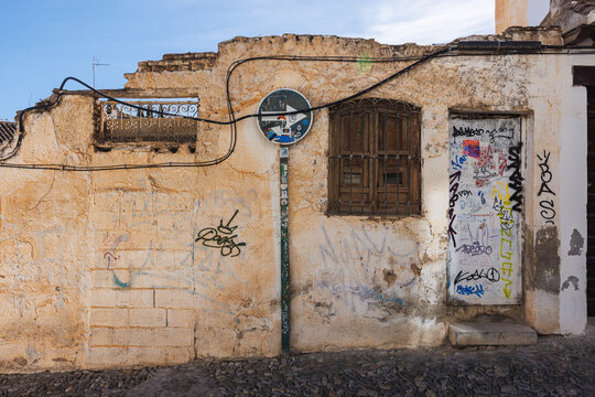 Graffiti on abandoned building and road sign