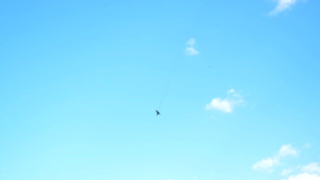 A fighter plane flies in the sky. Selective focus.
