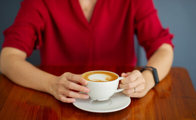 closeup hand drinking hot coffee with working, relax time