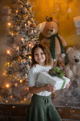 Christmas photo of a smiling girl with gift.