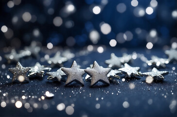 Artistic backdrop for Christmas featuring petite silver stars, sparkling glitter, and bokeh elements against a deep navy blue background.