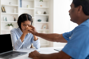 Support Concept. Mature Doctor Man Comforting Upset Indian Female Patient In Clinic