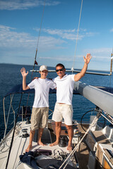 Dad and son on the yacht looking happy and cheerful