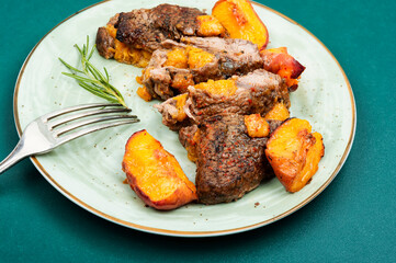Roasted meat beef steak with peach.
