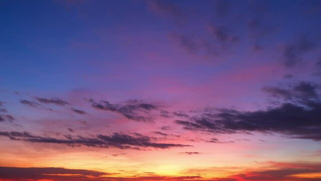 4K : Sunrise sky time-lapse - Majestic sunrise sky unfolds in rapid time-lapse, clouds dance in vibrant hues, painting dawn's canvas with a burst of colors. Natural movement background. 
