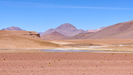 Bolivia, Avaroa National Park. Desert and mountain landscape with salt lakes and flamingos.