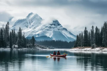 Foto op Canvas Male and female, two traveler in winter coat canoeing in Spirit Island on Maligne Lake at Jasper national park © Attasit