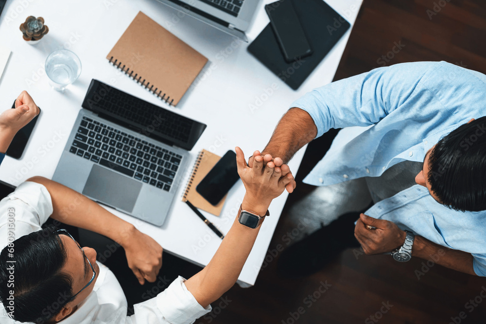 Poster top view diverse office employee worker high five after making agreement on strategic business marke