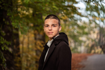 a 16-year-old teenager poses outside