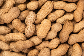 Peanut in a shell texture. Food background of peanuts, top view