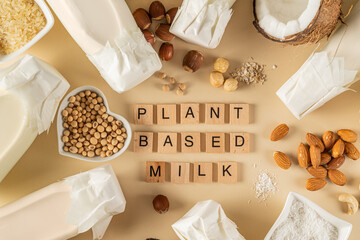 Plant based milk concept - selection of alternative milks on pastel background