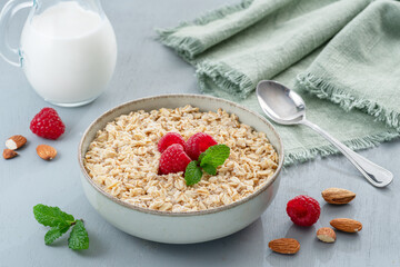 Bowl of porridge or oatmeal with fruits close up. Breakfast concept.