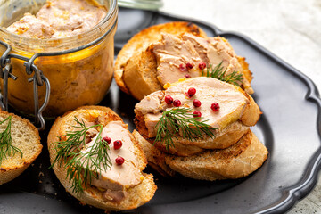 Sandwich with liver duck or goose pate. Decorated with red pepper and dill.