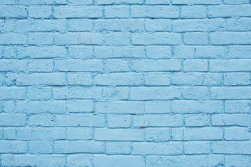 Light blue painted brick wall of historic 19th century building