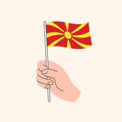 Cartoon Hand Holding North Macedonian Flag, Simple Vector Design. Flag of North Macedonia, Balkans, Flat Illustration
