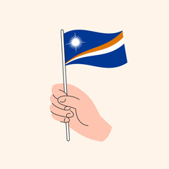 Fototapeta premium Cartoon Hand Holding Marshallese Flag, Simple Vector Design. Flag of Marshall Islands, Oceania, Isolated Flat Illustration