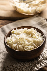 Fermented cabbage in a bowl on wooden cutting board