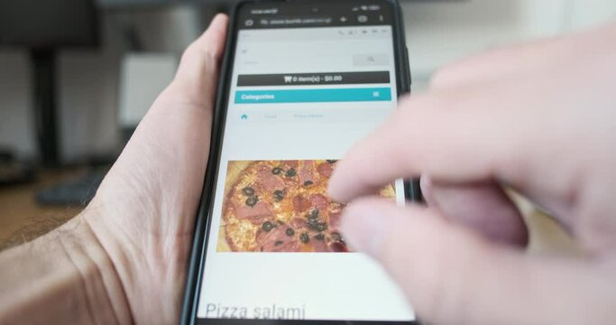 Man picks best pizza on site. Zooms in photo food, decides on choice and adds pizza to cart through online website application, smartphone screen. 