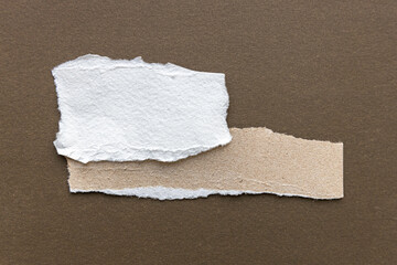 Paper different shapes scraps isolated on brown background White Ripped Piece of Paper isolated....