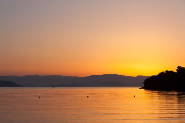 Fototapeta na wymiar Corfu sunrise with hills on background