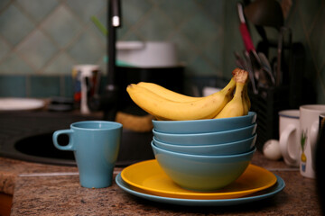 A bunch of bananas lying on a solid kitchen table. Sweet ripe bananas with yellow skin. Kitchen...